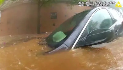 Vehicle submerged in downtown Atlanta flood waters. The occupant was rescued by an officer and a firefighter.