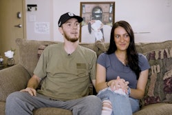 Officer Andrew Dotas and his wife Hannah. Officer Dotas is recovering at home from critical wounds he suffered during a July 14 ambush that killed another officer.