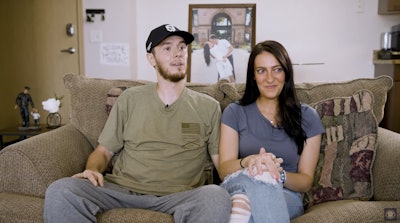 Officer Andrew Dotas and his wife Hannah. Officer Dotas is recovering at home from critical wounds he suffered during a July 14 ambush that killed another officer.