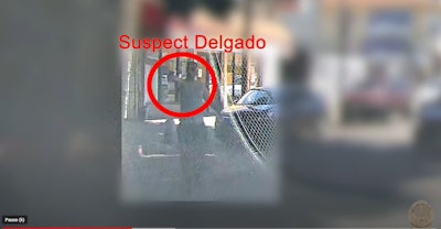 Suspect pointing handgun at LAPD officers patroling in the Olympic Division Aug. 6.