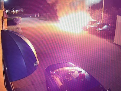 Michigan State Police vehicles burn outside a station in Sault St. Marie early Wednesday.