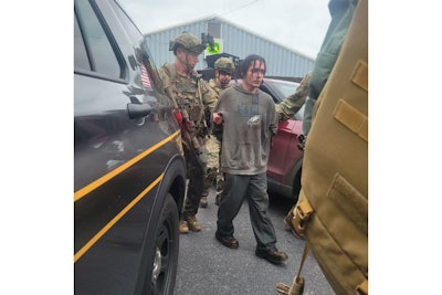 Escaped nurderer Danelo Cavalcante is led away by tactical officers. He was captured Wednesday after more than two weeks on the run.