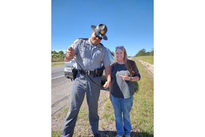 South Carolina Highway Patrol Sergeant Jonathan Oxandaboure and Mary Alice Simmons with king snake the trooper pulled from Simmons' car.