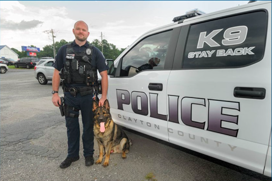 K-9 Waro and his Clayton County Police handler. Waro, a German shepherd, was killed early Saturday morning.