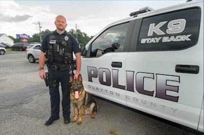 K-9 Waro and his Clayton County Police handler. Waro, a German shepherd, was killed early Saturday morning.
