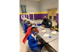 Bibb County school police officer Angelo Bellamy helps second graders achieve reading proficiency.