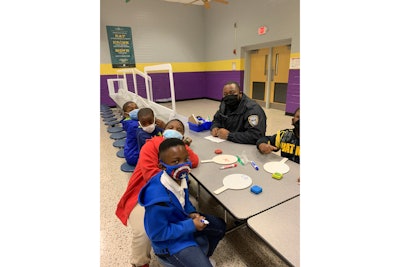 Bibb County school police officer Angelo Bellamy helps second graders achieve reading proficiency.