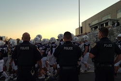 Chambersburg police officers work a local high school football game.