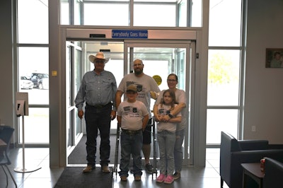 Sgt. Kyle Dockery enters the Huntsville, Texas, police station with his family. Dockery was shot multiple times on Oct. 12.