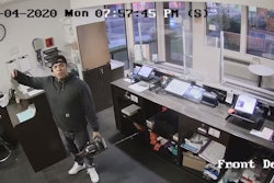 Photo showing Ronal Zendejas with a chainsaw inside the front office of a Sparks, Nevada, Motel 6.