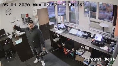 Photo showing Ronal Zendejas with a chainsaw inside the front office of a Sparks, Nevada, Motel 6.