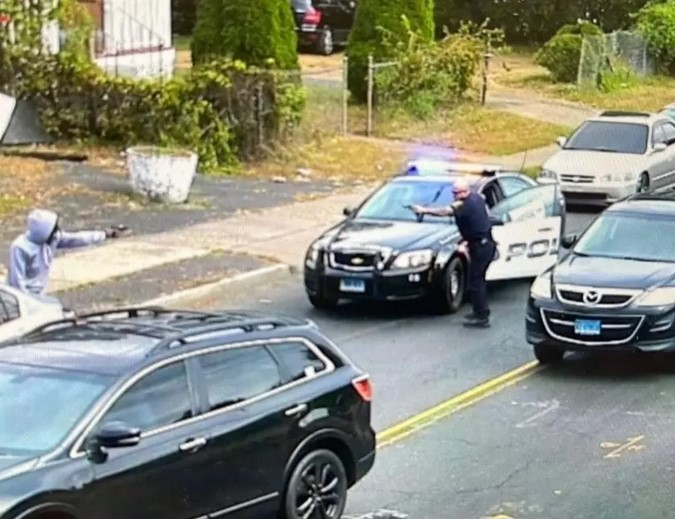 Still image from video released by City of Hartford shows police officer engaging armed suspect at less than a car length of range. The suspect was killed. The officer was not injured.