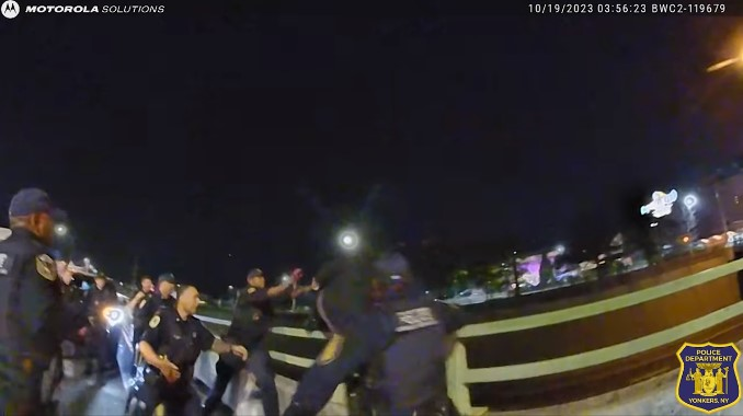 Yonkers, New York, police officer reach for a man as he jumps over the guardrail of a highway bridge. The officers were able to catch him and save his life.