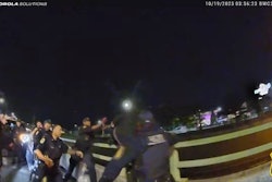 Yonkers, New York, police officer reach for a man as he jumps over the guardrail of a highway bridge. The officers were able to catch him and save his life.
