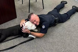 Chief Jason Newby of the Hopkinsville Police Department with rescue pit bull mix Bolo. The dog has been adopted by the department.