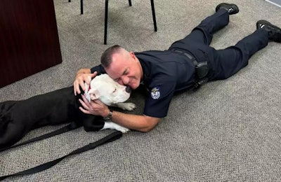 Chief Jason Newby of the Hopkinsville Police Department with rescue pit bull mix Bolo. The dog has been adopted by the department.