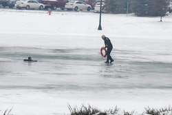 Commercial Motor Vehicle Officer Joe Schumaker walks out on a frozen pond in Dundee, Michigan. Schumaker fell through the ice taking a 12-year-old boy a flotation device.