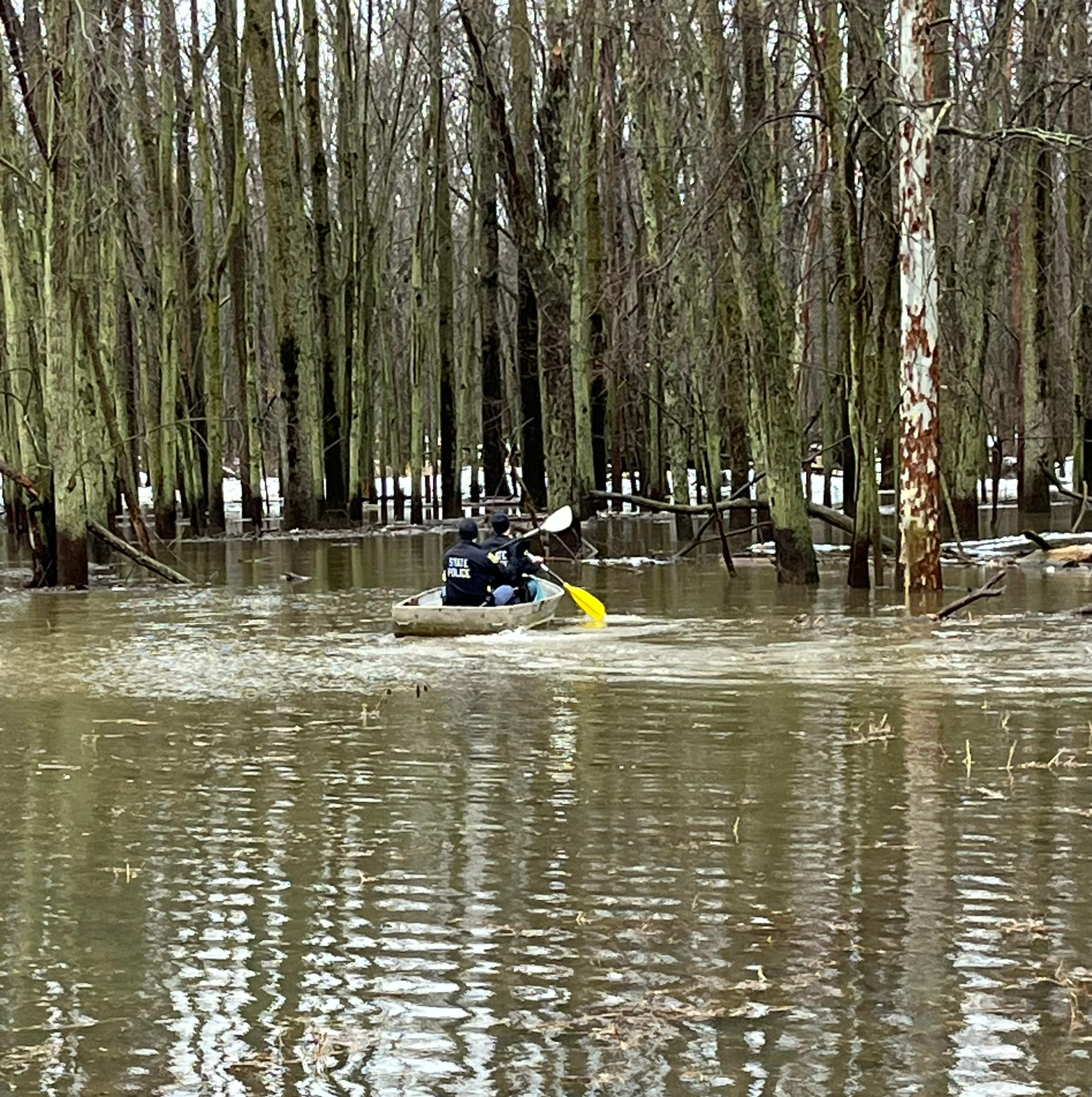 Michigan State Police officers used a rowboat Friday to capture a suspect who jumped in a river.