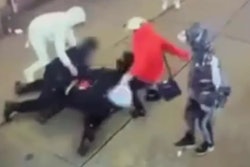 Still from NYPD video shows migrants kicking NYPD officers after they were knocked to the sidewalk Saturday, authorities say.
