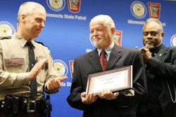 Minnesota DPS Commissioner Bob Jacobson presents an award to Col. Matt Langer, chief of the Minnesota State Patrol. Langer is stepping down in April.