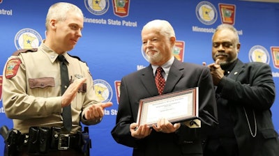 Minnesota DPS Commissioner Bob Jacobson presents an award to Col. Matt Langer, chief of the Minnesota State Patrol. Langer is stepping down in April.