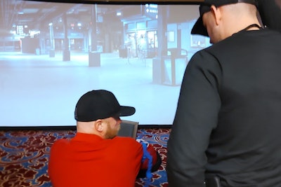 A trainer who serves as a coach confirms the tourniquet has been applied properly by a fellow officer during a training scenario at ILEETA.