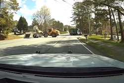 Officer's view of a front loader driven by a helpful civilian engaging with a front loader driven by a suspect during a Norcross, Georgia, incident Saturday. The good guy won, flipping the suspect's heavy equipment on its side. Police say no one was hurt.