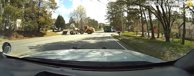 Officer's view of a front loader driven by a helpful civilian engaging with a front loader driven by a suspect during a Norcross, Georgia, incident Saturday. The good guy won, flipping the suspect's heavy equipment on its side. Police say no one was hurt.