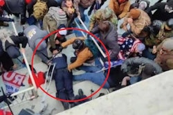 The Department of Justice says this photo shows Jeffrey Sabol holding a baton against the throat of a downed police officer during the Jan. 6, 2021, riot at the U.S. Capitol Building.