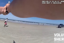 Volusia County, Florida, Sheriff's deputy pursues gun-wielding suspect toward the surf on New Smyrna Beach.