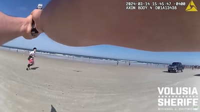 Volusia County, Florida, Sheriff's deputy pursues gun-wielding suspect toward the surf on New Smyrna Beach.