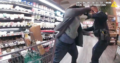 An image taken from body-worn camera video shows the moment when a Boulder, CO, officer was stabbed in the shoulder by a woman refusing to leave a grocery store earlier this week.