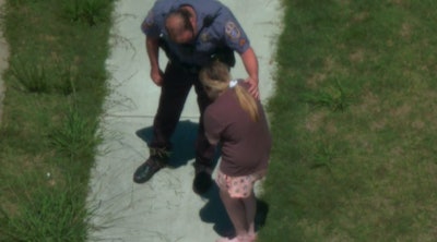 Gwinnett County Police officer consoles a 15-year-old girl who ran away from home and was spotted by the police Aviation Unit.