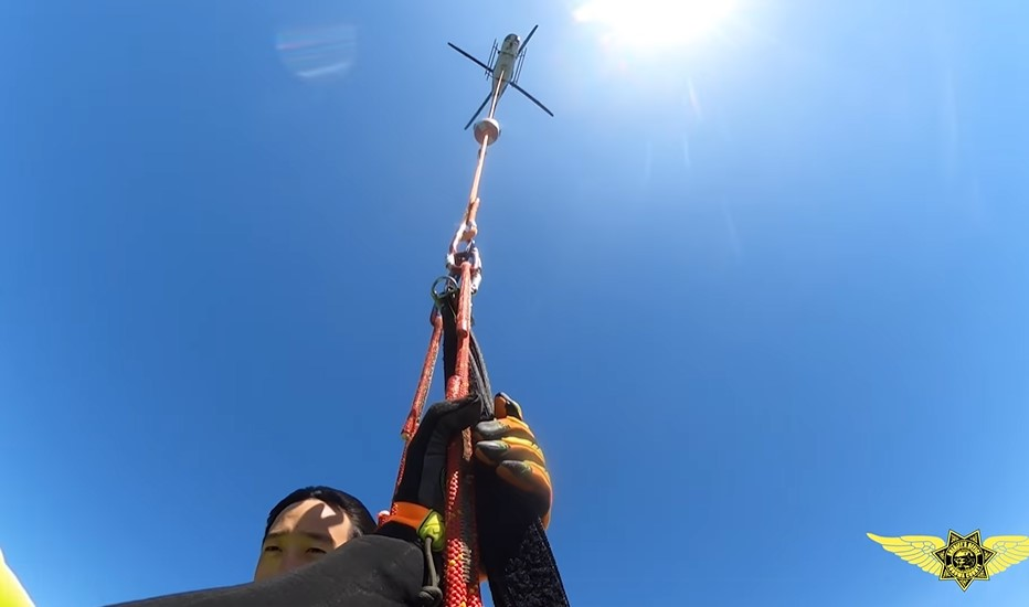 Marin County, California, Sheriff's deputies helicopter into Tomales Bay to rescue four people from an overturned boat.