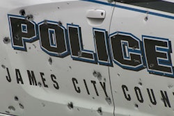A James City County, Virginia, Police officer was ambushed in this patrol car Wednesday by a man firing a rifle. Police say the vehicle had more than 100 bullet holes. The officer suffered minor injuries.