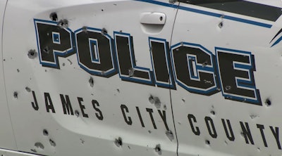 A James City County, Virginia, Police officer was ambushed in this patrol car Wednesday by a man firing a rifle. Police say the vehicle had more than 100 bullet holes. The officer suffered minor injuries.