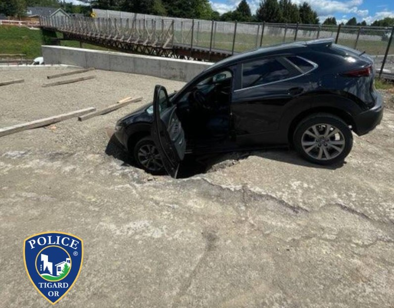 An Oregon bank robbery suspect tried to escape a police pursuit by driving through a construction site and crashed into a hole.