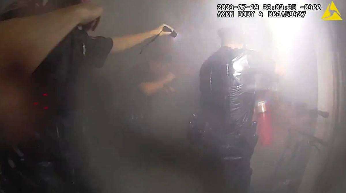 NYPD officers discharge a fire extinguisher in an apartment building after rescuing a woman from her apartment. The department this week released body-worn camera video of the rescue.