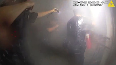 NYPD officers discharge a fire extinguisher in an apartment building after rescuing a woman from her apartment. The department this week released body-worn camera video of the rescue.