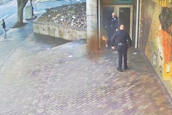 An officer is shown on video putting out the fire outside the LAPD station earlier this week.