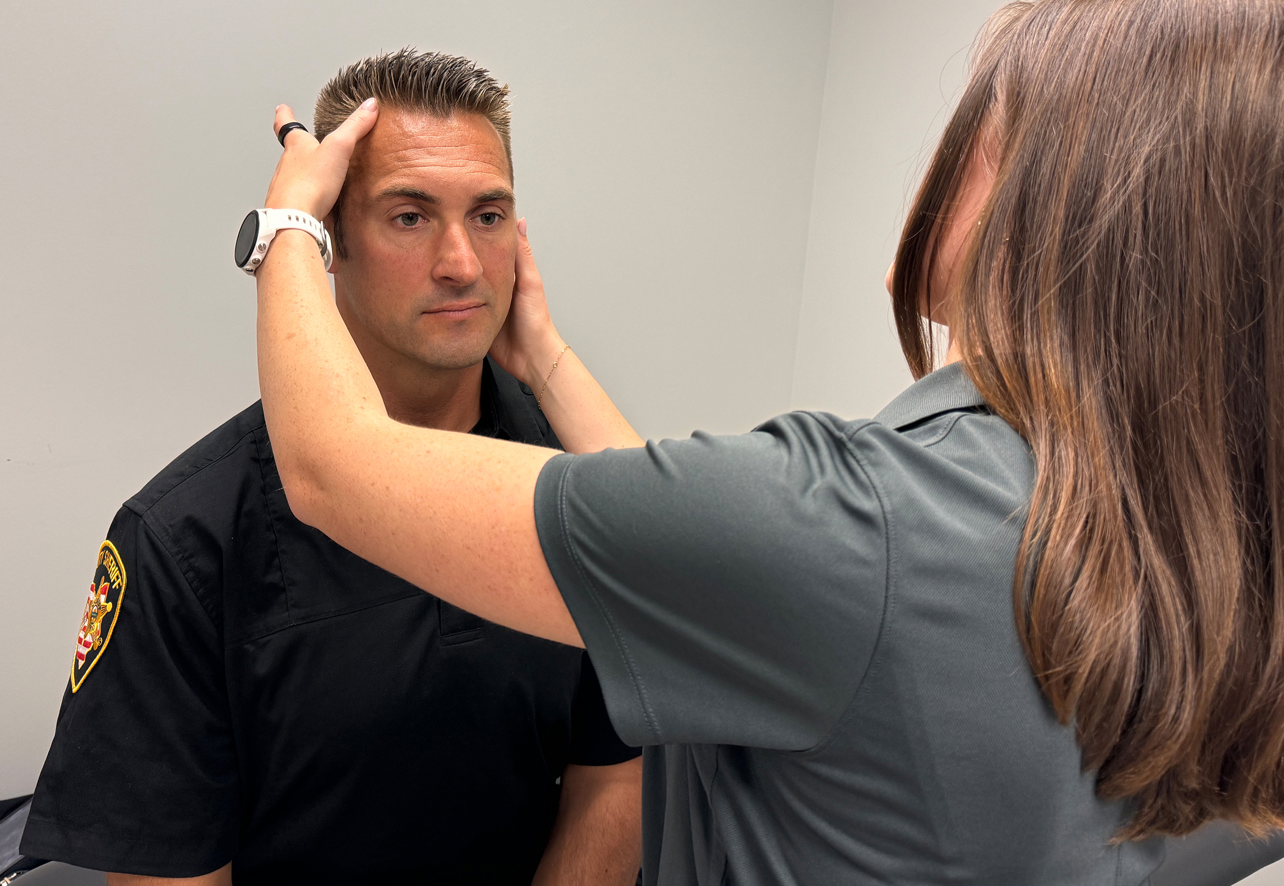 Deputy Josh Walters is examined by certified athletic trainer Kate Brubaker at the Ohio State University Wexner Medical Center.