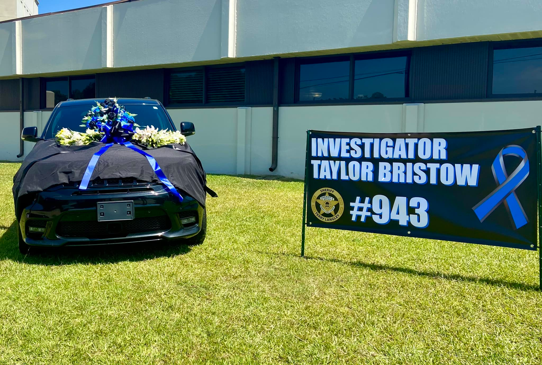 Investigator Taylor Bristow's police vehicle has been set up as a memorial outside the headquarters of the Carroll County Sheriff's Office.