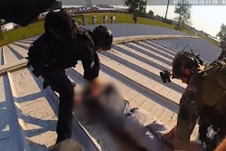 Butler Township Police officers surround the suspect after he was killed by Secret Service countersnipers.