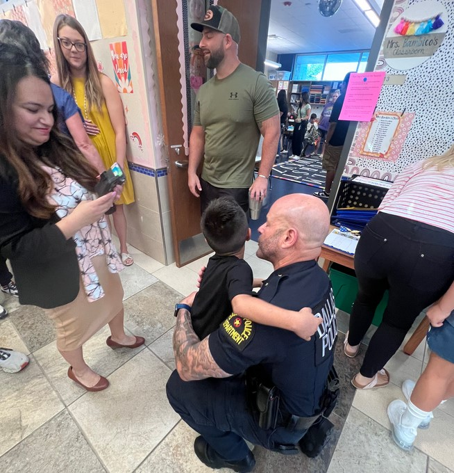 Dallas Police Chief Eddie Garcia with Nicholas De La Roche. Nicholas' father Sr. Cpl. Jose De La Roche died last year after a medical emergency at home. The chief and several Dallas officers escorted Nicholas to his first kindergarter classroom.