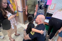 Dallas Police Chief Eddie Garcia with Nicholas De La Roche. Nicholas' father Sr. Cpl. Jose De La Roche died last year after a medical emergency at home. The chief and several Dallas officers escorted Nicholas to his first kindergarter classroom.