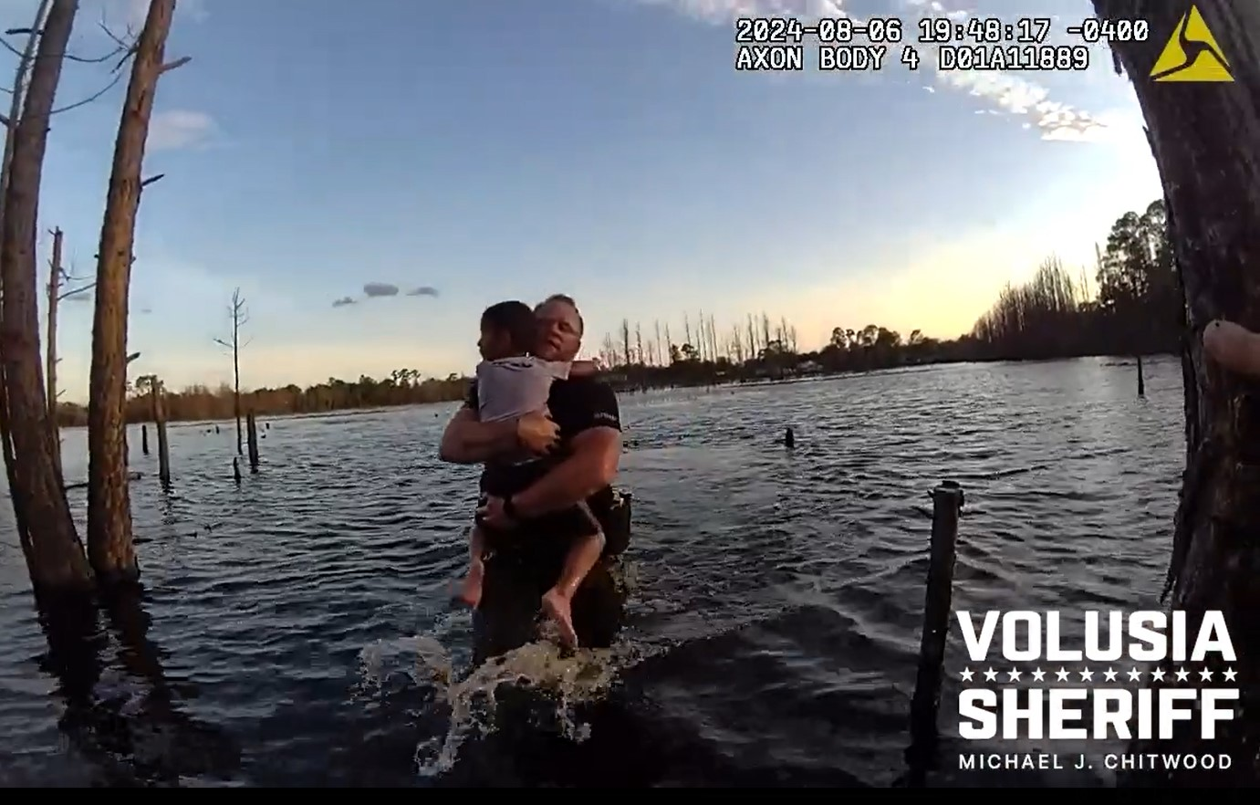 Deputy Wes Brough of the Volusia County (Florida) Sheriff's Office rescues a child from a local pond.