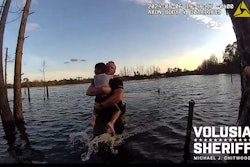 Deputy Wes Brough of the Volusia County (Florida) Sheriff's Office rescues a child from a local pond.