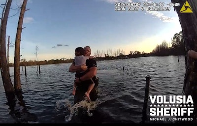 Deputy Wes Brough of the Volusia County (Florida) Sheriff's Office rescues a child from a local pond.