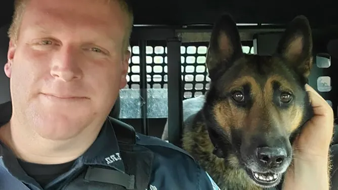 Erwin (Tennessee) Police K-9 Scotty with his handler. Scotty was killed Friday in a Hurricane Helene flash flood.