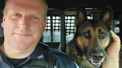 Erwin (Tennessee) Police K-9 Scotty with his handler. Scotty was killed Friday in a Hurricane Helene flash flood.